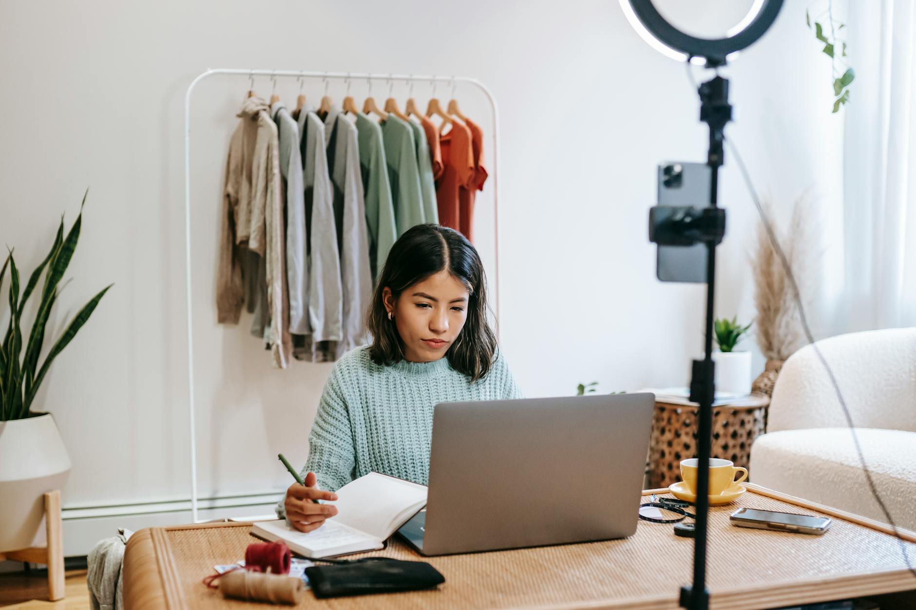 focused fashion designer working on instagram stories and reels at home
