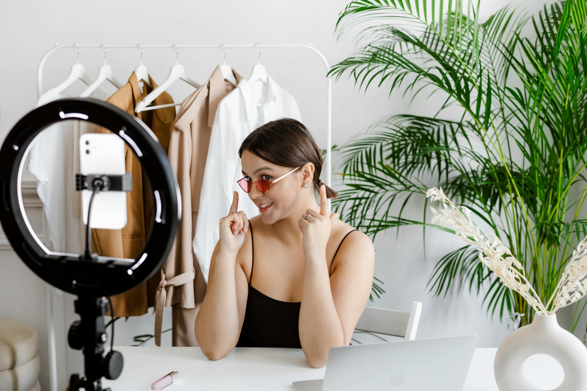 a fashion designer showing her designs to a video recording