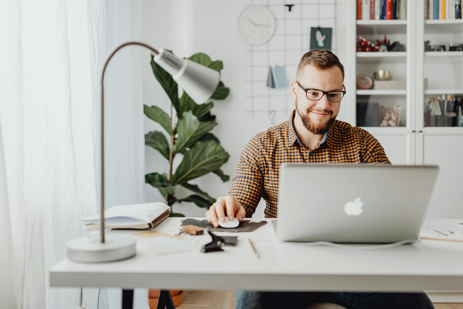 male designer using macbook to market his fashion designs