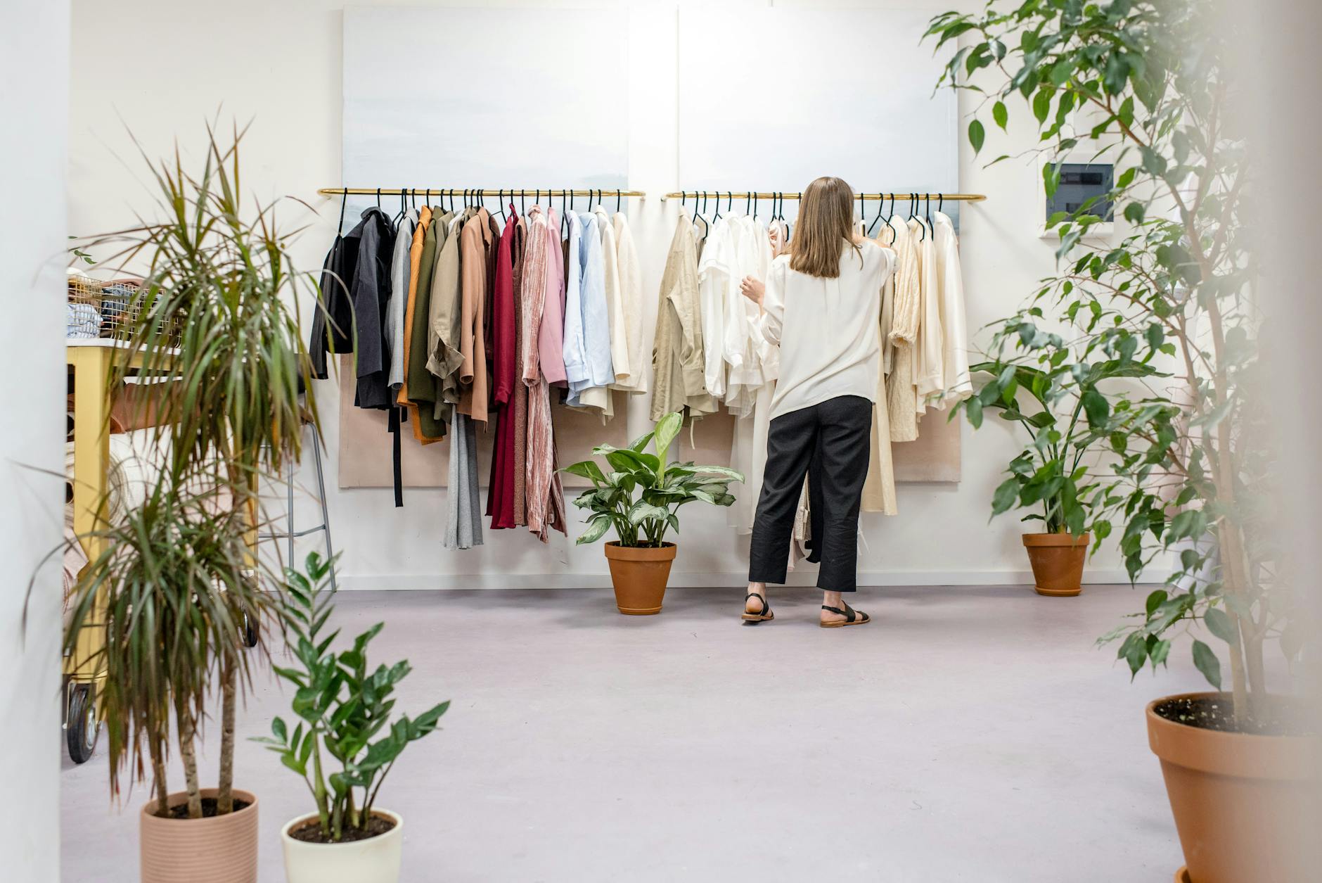 fashion designer fixing clothes on the rack